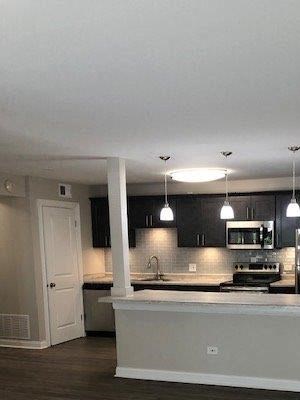 Beautiful, Open Concept Kitchen With Huge Island & Pendant Living Overlooking Living Room